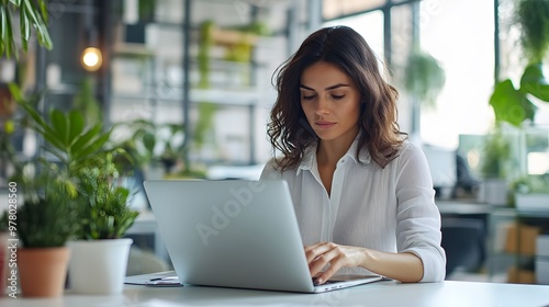 Woman Typing on a Laptop in a Modern Office Space Free Download Woman Typing on a Laptop in a Modern Office Space - GFXLoad