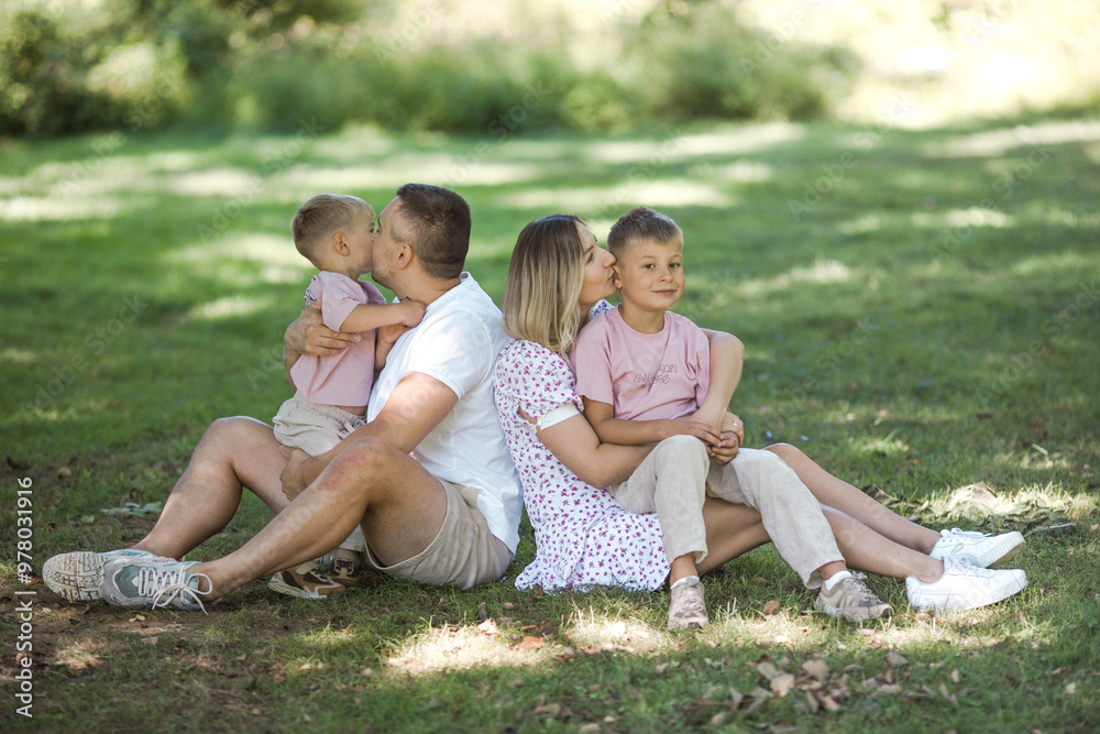 Kiss delivery for dad and mom. Cropped shot of a young family spending time together outdoors. Kiss delivery for dad and mom. Cropped shot of a young family spending time together outdoors.