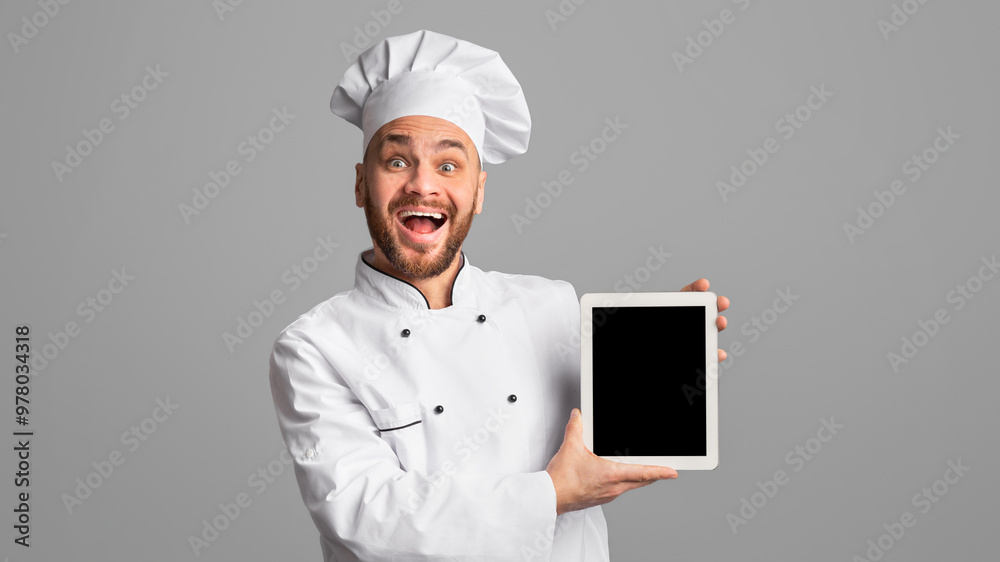 Professional Chef Showing Tablet Computer Blank Screen Recommending Food Delivery Application Or Online Menu Over Black Background. Studio Shot, Mockup Professional Chef Showing Tablet Computer Blank Screen Recommending Food Delivery Application Or Online Menu Over Black Background. Studio Shot, Mockup