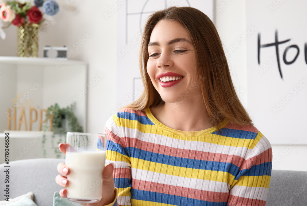 Young woman with glass of milk at home Young woman with glass of milk at home