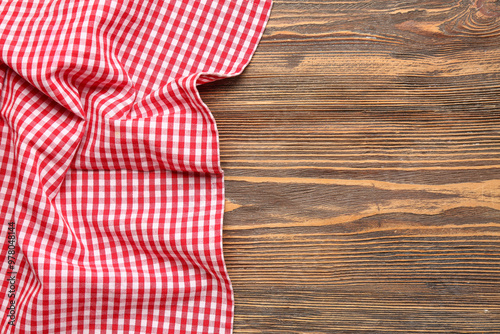 Red checkered napkin on wooden background