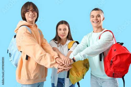 Teenage students putting ha...
