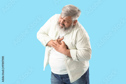 Senior man having heart att...