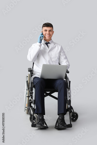 Young male doctor in wheelc...