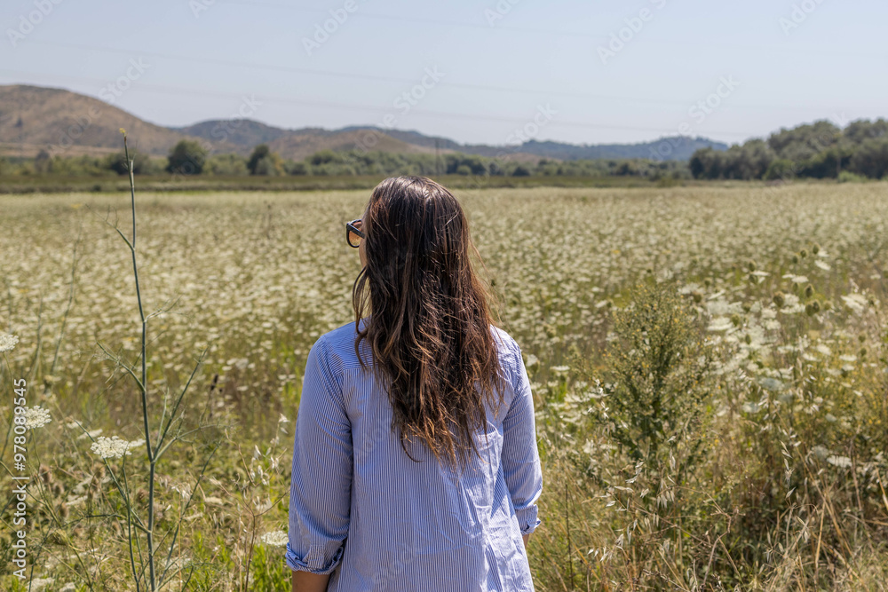 woman looking at flower field in Sarande city in Albania. woman looking at flower field in Sarande city in Albania.