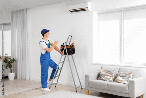 Male worker repairing air c...