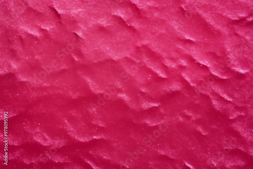 Close-up view of pink sand, highlighting its delicate texture and gentle color variations, evoking a tranquil beach atmosphere.
