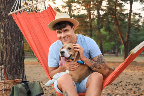 Young man with Beagle dog s...