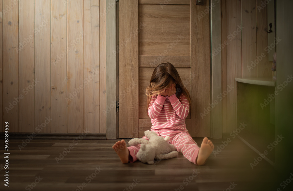 sad upset little girl sitting on bedroom floor crying sad upset little girl sitting on bedroom floor crying