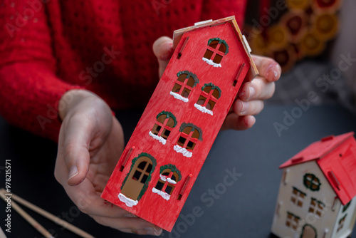 Sustainableminded Christmas cozy atmospheric festive decor in modern scandinavian home handmade decoration. Tutorial for making do it yourself craft wooden houses. Seasonal activity for kids photo