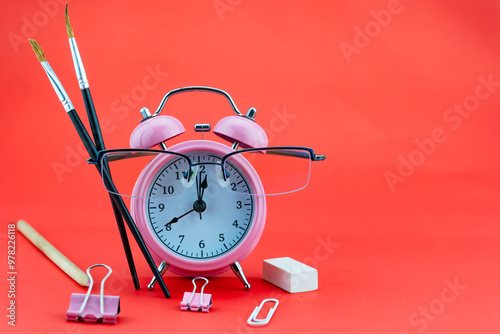 Concept Education or business Alarm clock and teacher glasses, Business objects isolated on colorful background, Back to school concept photo