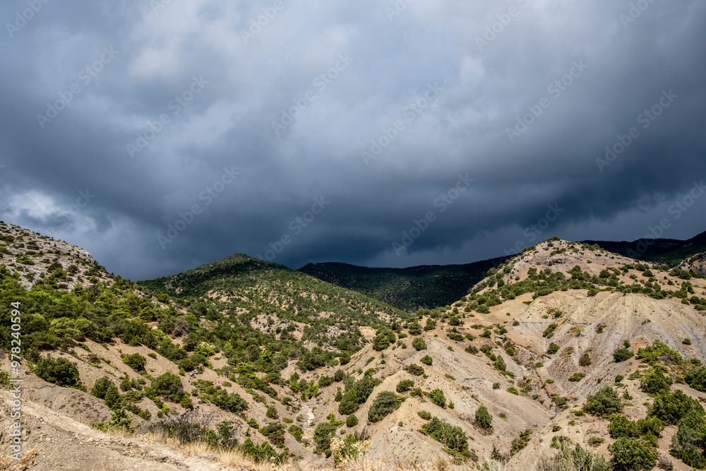 Hills covered with forest against the background of clouds. Hills covered with forest against the background of clouds.