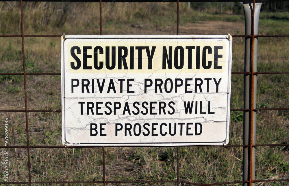 Security Notice - Private Property sign attached to a wire fence Security Notice - Private Property sign attached to a wire fence
