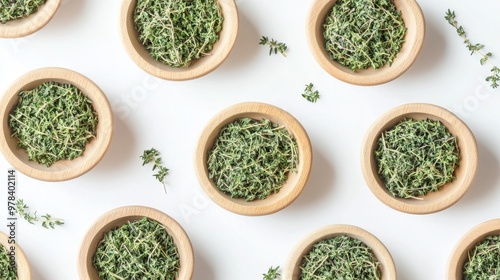 4. High-angle shot of wooden bowls filled with fresh thyme leaves and dried thyme powder, meticulously arranged on a pristine white surface