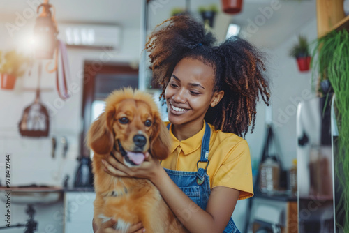 Cute dog on groomer's table during haircut. African American pet groomer styling a dog in a bright grooming salon. Dog sitting on grooming table looking relaxed and comfortable during beauty procedure photo