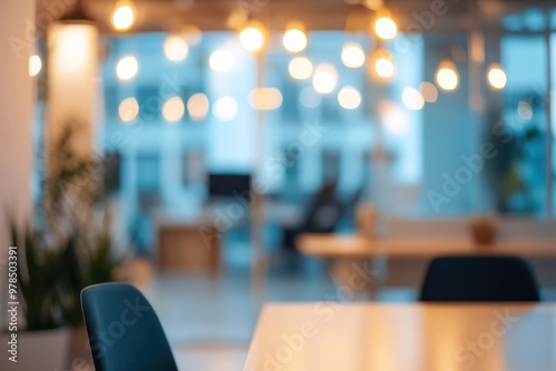 A modern office space with a blurred background, featuring lighting and furniture.