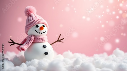 A snowman in a pink hat and scarf stands in the snow, with a soft pink bokeh background and falling snowflakes photo