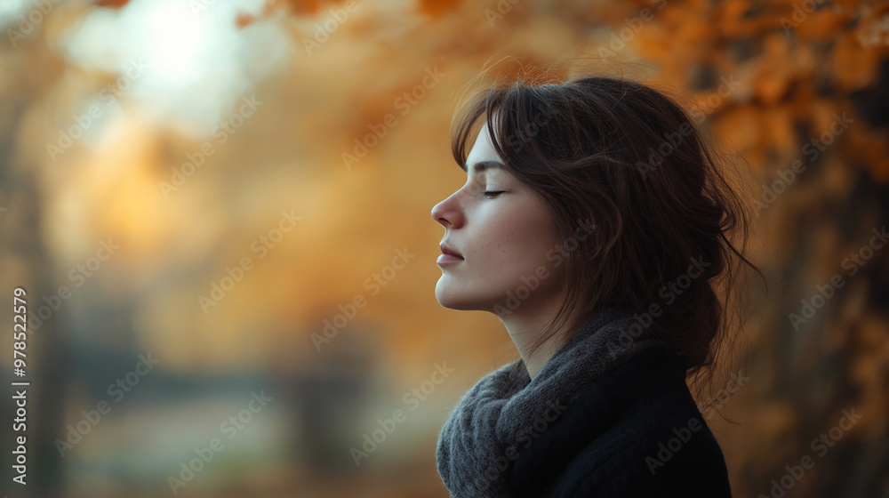 A woman stands in a tranquil outdoor setting, eyes closed, reflecting on her thoughts amidst a backdrop of vibrant autumn foliage, copy space A woman stands in a tranquil outdoor setting, eyes closed, reflecting on her thoughts amidst a backdrop of vibrant autumn foliage, copy space