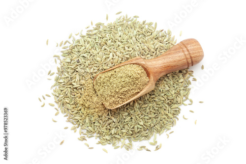 A wooden scoop filled with organic Fennel Seeds (Foeniculum vulgare) Badi saunf powder, placed over a heap of Fennel Seeds, isolated on a white background. photo