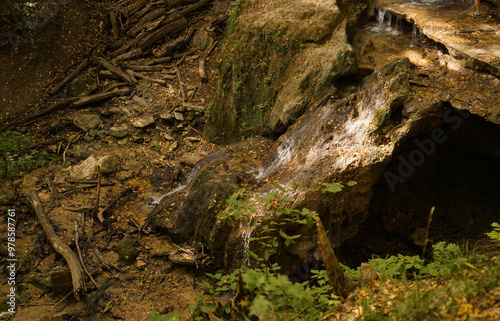 Natural waterfall in yellow forest in autumn