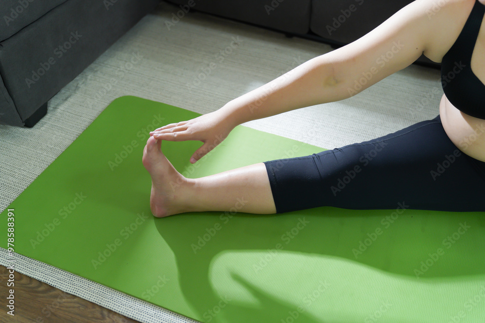 Fototapeta premium Overweight woman exercising for weight loss. exercise with dumbbells in stretching positions at home in the living room Cheerful Fat woman diet healthy lifestyle concept.