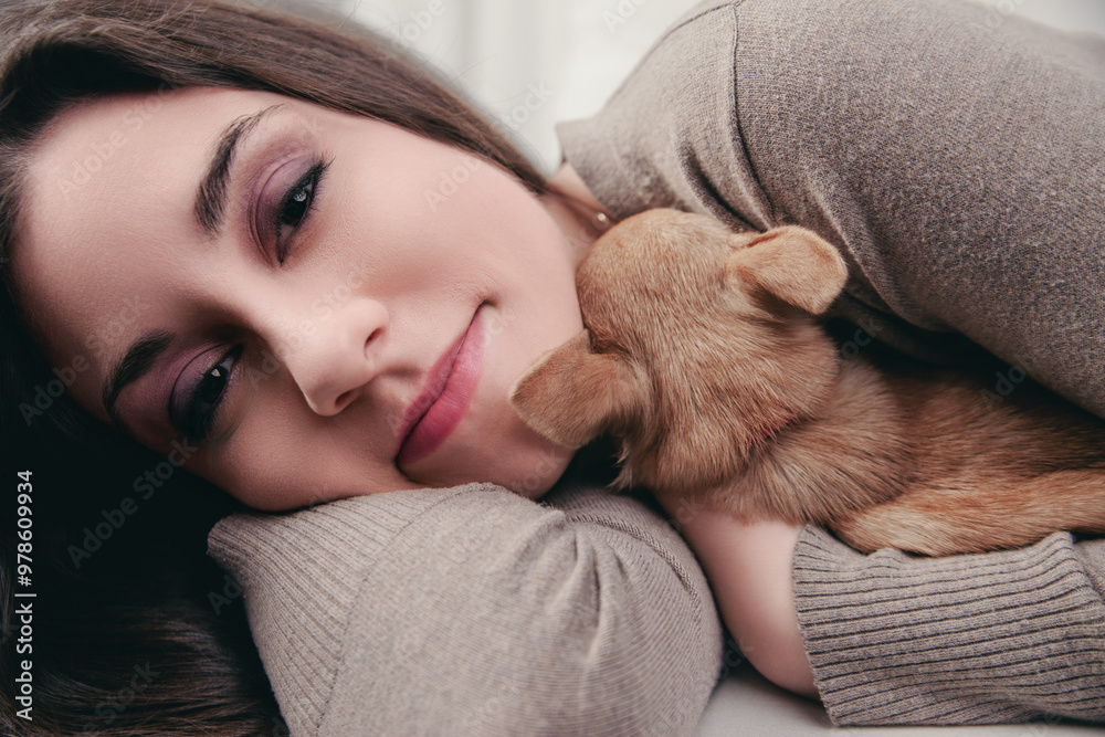Puppy sleeps soundly in woman's gentle embrace Puppy sleeps soundly in woman's gentle embrace