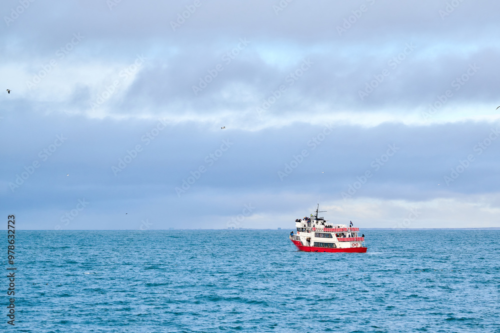 Ship floating on rippling sea under cloudy sky Ship floating on rippling sea under cloudy sky