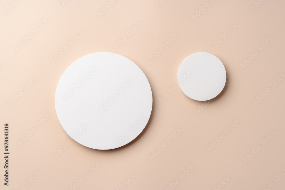Simple Design With Two White Circular Shapes Against a Soft Beige Background in Modern Interior Space Simple Design With Two White Circular Shapes Against a Soft Beige Background in Modern Interior Space