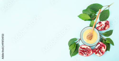 Rosh hashanah, jewish new year holiday, background with pomegranate and honey, traditional food for celebration  photo