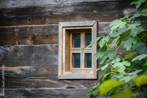 Old window on a wooden brown house