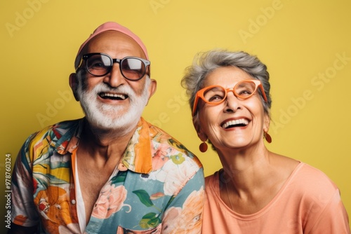 A man and woman are smiling and wearing glasses