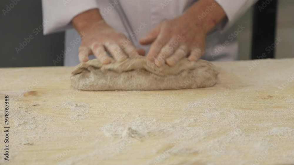 The baker works with the dough, forms and prepares it for further proofing. The baker works with the dough, forms and prepares it for further proofing.
