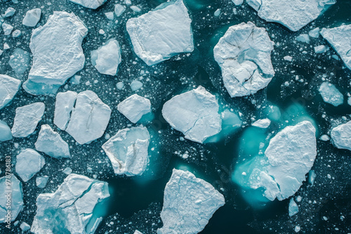 Various icebergs drift peacefully in striking turquoise waters, showcasing the beauty of the Arctic landscape during a clear, bright day.