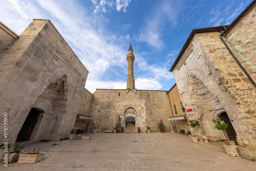 Exterior view of Hizirbey mosque and minaret under blue sky in Egirdir. photo