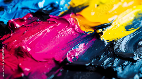 CMYK inks being mixed on a palette, showing the gradual blending of cyan, magenta, yellow, and black photo