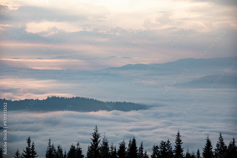 Majestic Mountain Landscape Covered in Mist with Sun Rays Breaking Through Clouds Majestic Mountain Landscape Covered in Mist with Sun Rays Breaking Through Clouds