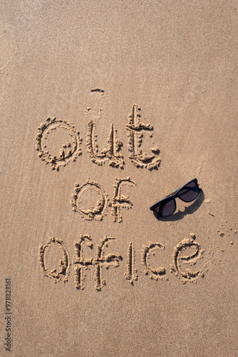 Out of Office inscription in the sand