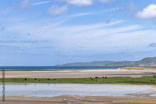 Low tide at Gweebarra Bay, Ireland, reveals Atlantic shorelines interspersed with water lines, creating a natural canvas of earthy tones photo