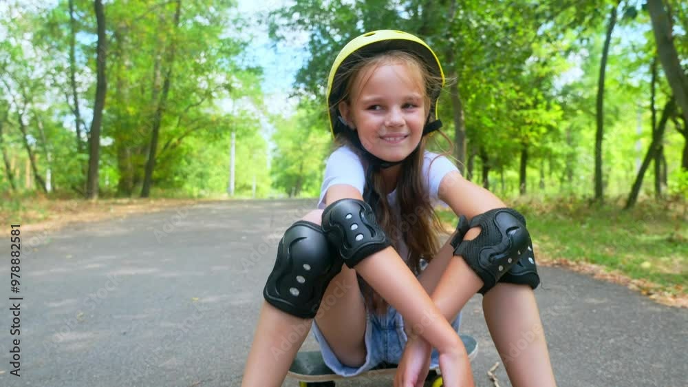 child with skateboard outdoor. Portrait little girl with a skateboard in the park. skateboarder child lifestyle looking at the camera close-up outside. child with skateboard outdoor. Portrait little girl with a skateboard in the park. skateboarder child lifestyle looking at the camera close-up outside.