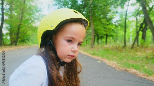 Portrait of Smiling little child girl kid skateboarding at the park. Preschool girl enjoy and having fun outdoor lifestyle practicing extreme sport skateboard skating on summer vacation photo