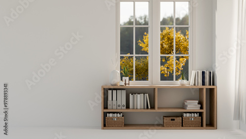 Fototapeta Naklejka Na Ścianę i Meble -  A lower bookcase against the window and an empty space on a white wall in a bright contemporary room