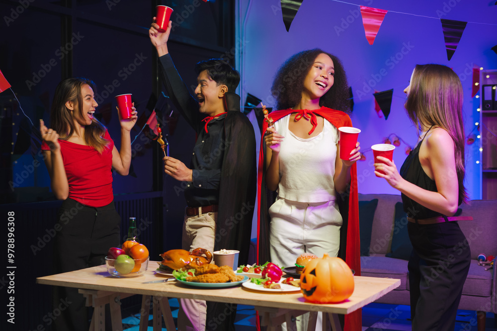 Dinner and group of people celebrating together at Halloween party. Friends are happy and celebrating with food, wine and friendship of love and cheers of champagne at the event.