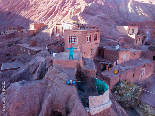 Aerial view of a beautiful village with mud brick houses surrounded by arid mountains and rock formations, Bamyan, Afghanistan. photo