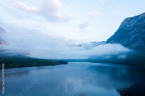 Aerial view of serene Lake Bohinj surrounded by majestic mountains and misty sky, Stara Fuzina, Slovenia. photo