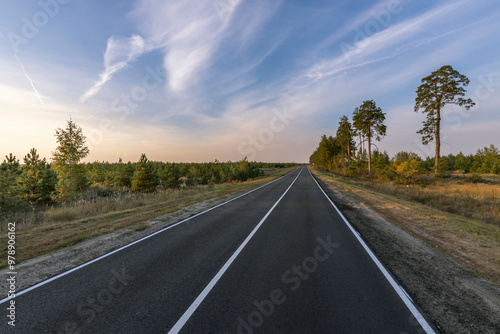 A long road with trees in the background