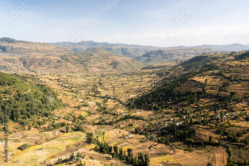 Aerial view of lush farmland nestled in a serene valley surrounded by majestic mountains, Oromia, Ethiopia. photo