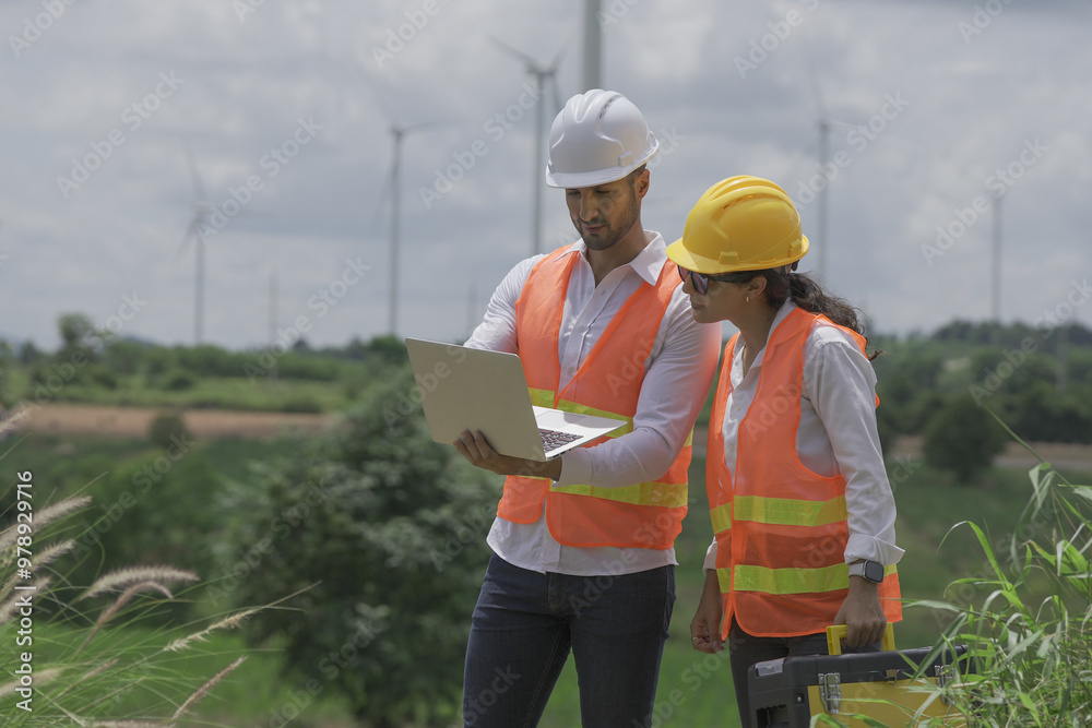 technician working outdoor at wind turbine field. Renewable energy engineer working on wind turbine projects, Environmental engineer research and develop approaches to providing clean energy sources technician working outdoor at wind turbine field. Renewable energy engineer working on wind turbine projects, Environmental engineer research and develop approaches to providing clean energy sources