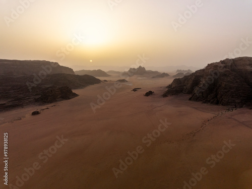 Aerial view of serene desert landscape with majestic rock formations at sunset, Aqaba, Jordan.