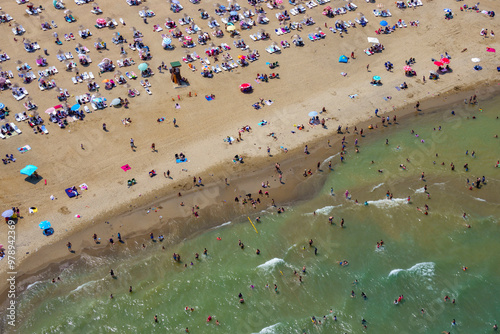 Aerial view of a crowded sandy beach with sunbathers and umbrellas by the Black Sea, Sariyer, Turkey. photo