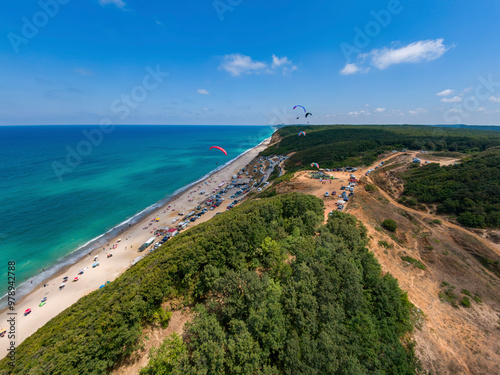 Aerial view of Ormanli beach with paragliders and turquoise water, Catalca, Turkey. photo